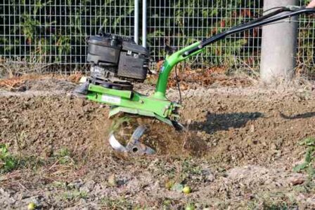 Clean Rototiller Tines With a Pipe-Held Screwdriver Image